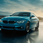 Teal BMW 4 Series on city highway