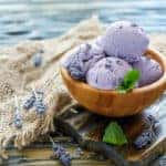 Delicious lavender ice cream in a wooden bowl.