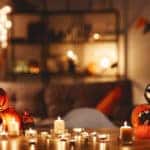 Halloween party decorations, lit candles and jack-o'-lanterns