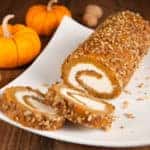 Sliced pumpkin roll on a plate.