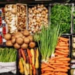 An aerial view of various vegetables, including mushrooms, carrots and asparagus at a local supermarket.