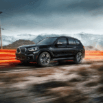 BMW X3 SUV on a desert road with blurred lines of light in the background