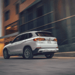 hind view of the BMW X5 as it travels through the city