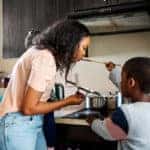 Mom and son preparing a meal together in their kitchen.