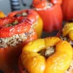 Four bell peppers stuffed with quinoa and roasted.