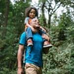 Dad and young boy hiking on a trail
