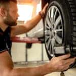 Car mechanic is changing tire
