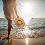 Close-up of young woman in white sun dress