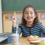 Little girl eating healthy at school