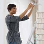 Woman fitting lightbulb