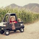 A young boy is ready to work hard on the farm.