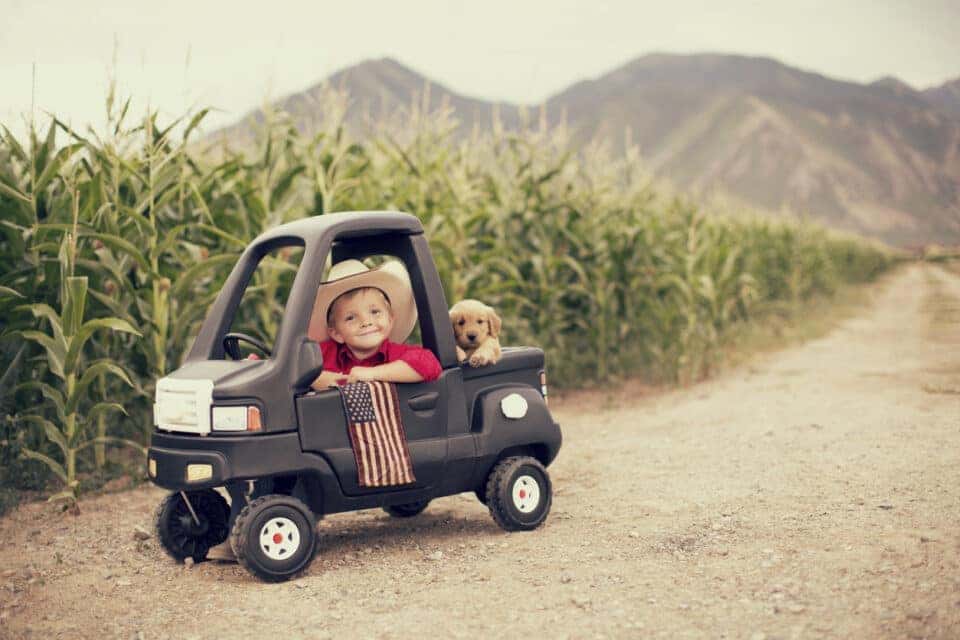 A young boy is ready to work hard on the farm.