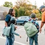 Toyota Models for Students and Families - young family walking from school to suv in the parking lot
