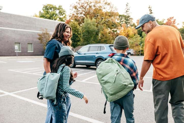 Toyota Models for Students and Families - young family walking from school to suv in the parking lot