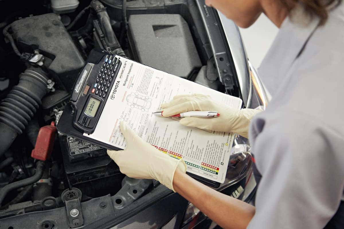 How to prepare your Toyota for the winter season | technician looking over car chart How to prepare your Toyota for the winter season | technician looking over car chart