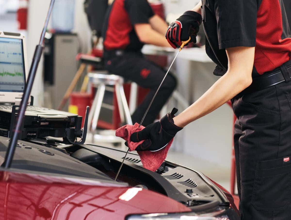 How to prepare your Toyota for the winter season | technician checking car oil How to prepare your Toyota for the winter season | technician checking car oil