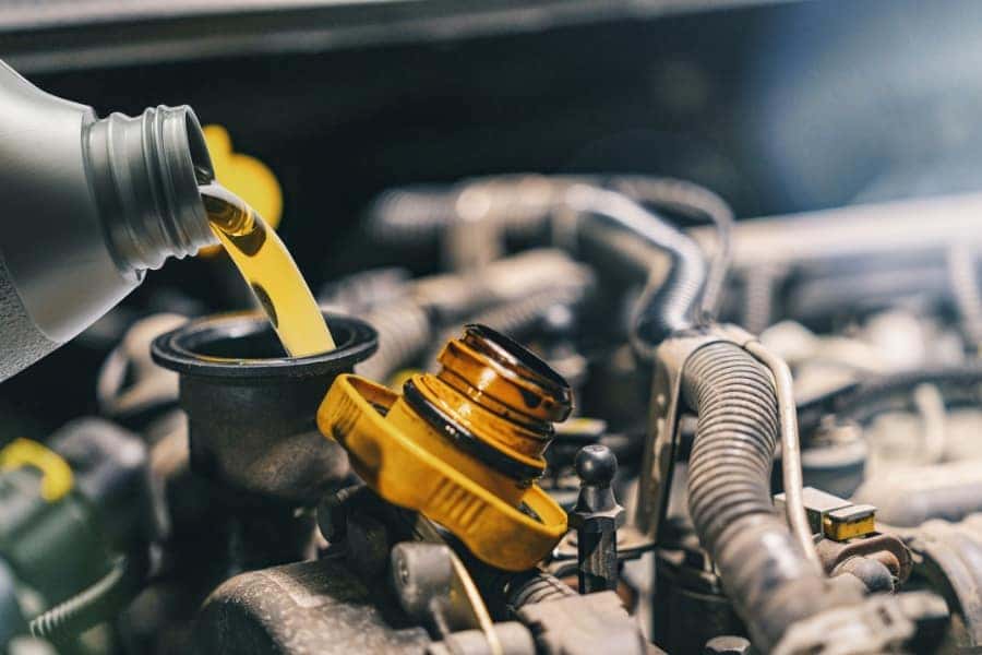 Technician performing Volkswagen oil change.