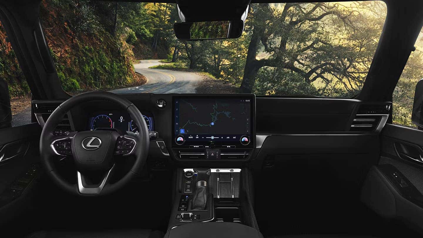 Interior of the Lexus GX 550 Overtrail Plus in Black NuLuxe / Olive Ultrasuede® and Black Grained trim featuring Lexus Interface with 14-inch touchscreen display in the cockpit area.