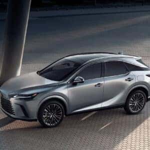 Lexus RX in silver parked in an urban setting under modern architectural columns.