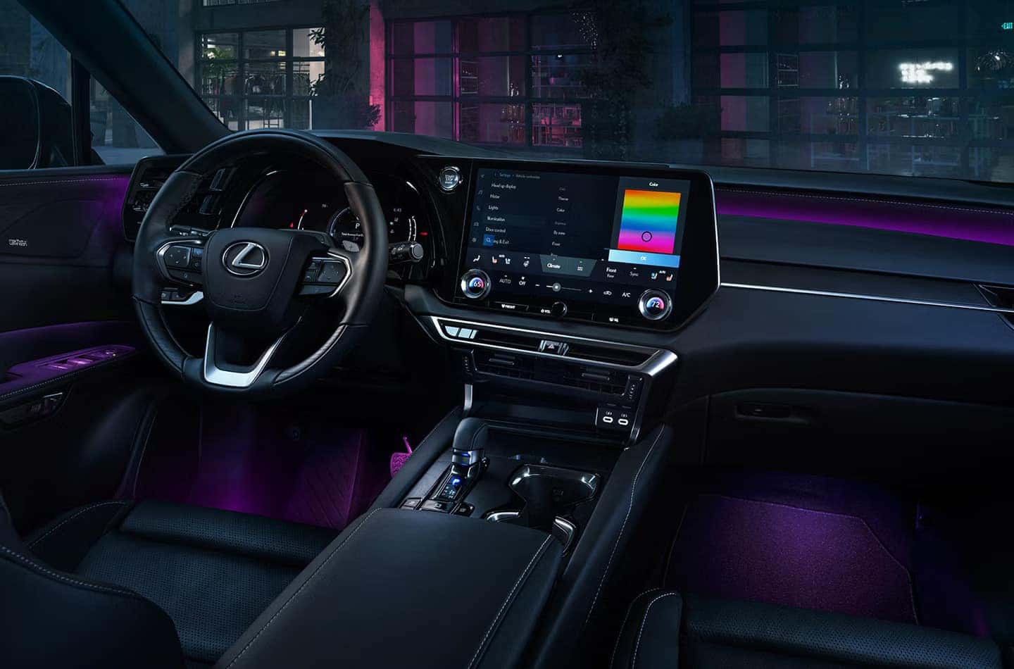 Interior view of the 2025 Lexus RX, showcasing the illuminated dashboard and ambient lighting customization