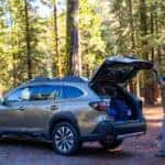 person unloading a subaru at an off road forest