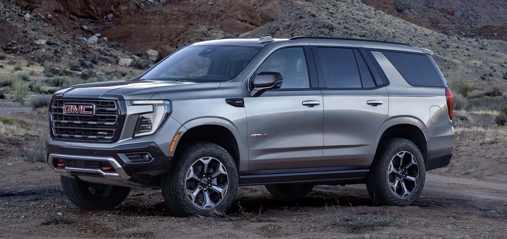 2026 GMC Yukon For Sale Austin Tx Dealer Covert side view in greg off-road in the mountains