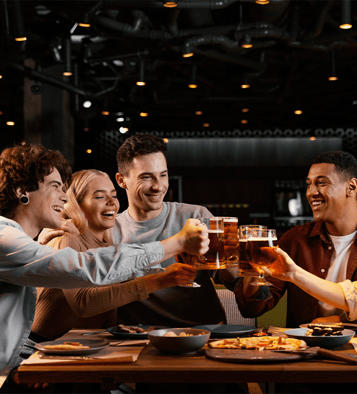 Toyota Dealer Near Clearfield | Friends sitting together at a bar and smiling