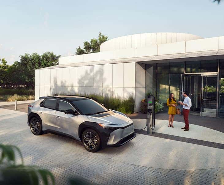 How to prepare your home for your new Electric Vehicle at Delaney Toyota of DuBois in DuBois, PA | 2024 Toyota bZ4X charging by a charging station