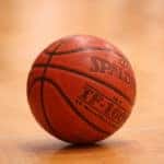 Basketball sitting still on a basketball court.