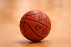 Basketball sitting still on a basketball court.