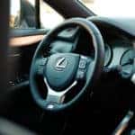 Lexus steering wheel and dashboard with a black leather interior.