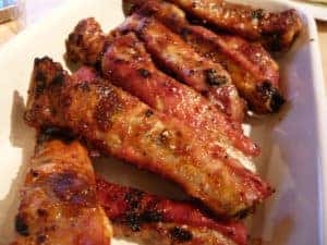 Large plate of grilled barbecue ribs.