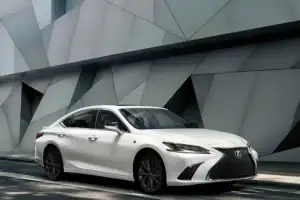 A white 2025 Lexus ES driving down the road