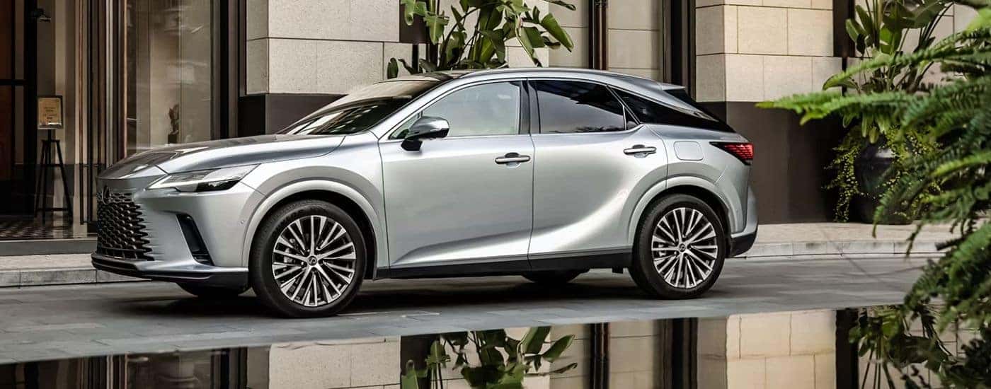 A silver 2026 Lexus RX 350 Premium parked by a building.