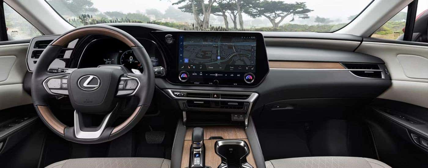 Gray and wood-detailed interior of a 2026 Lexus RX 350h Luxury.