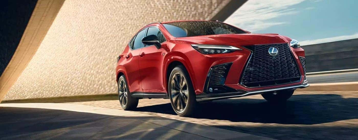 A red 2024 Lexus NX driving.