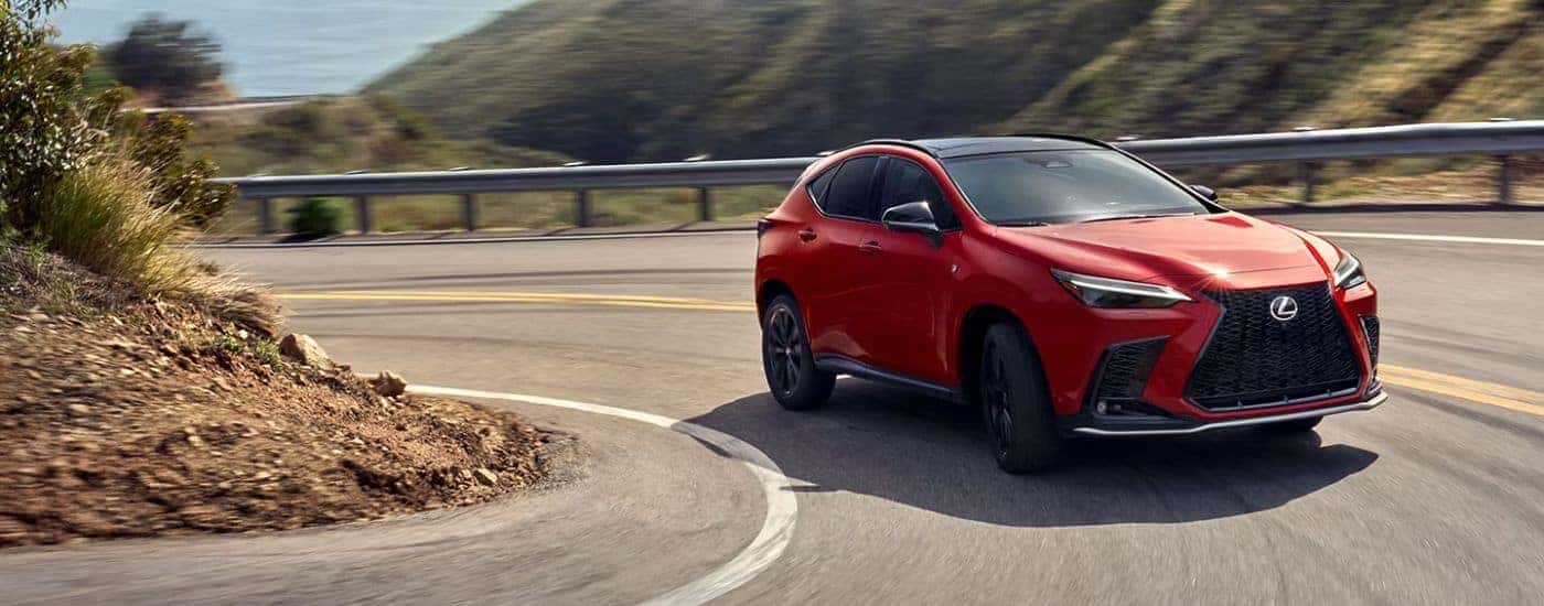 A red 2026 Lexus NX 350 F Sport turning a corner.