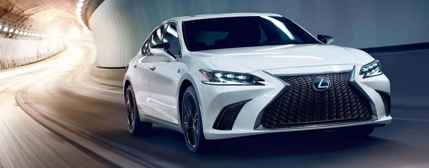A white 2024 Lexus ES driving in a tunnel.
