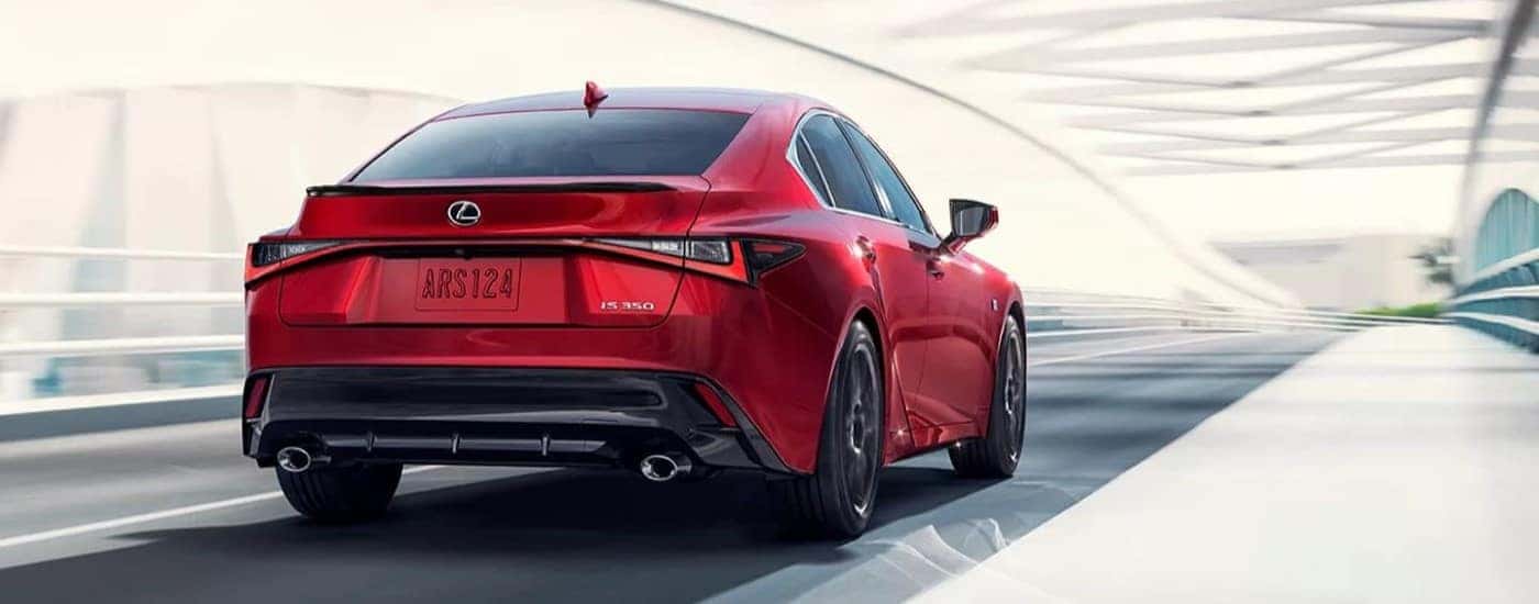 Rear view of a red 2023 Lexus IS 350 in a tunnel.