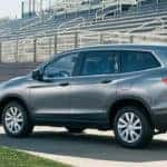 Family loading Honda Pilot on Football Field