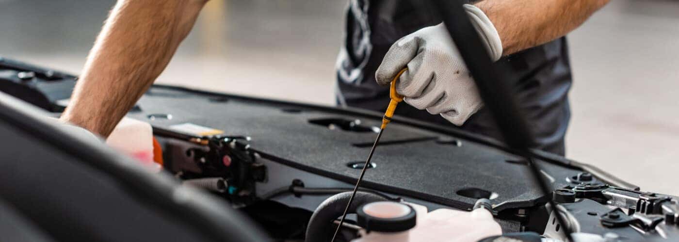mechanic checking oil