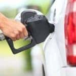 Close shot of someone filling up tank of gas for their car