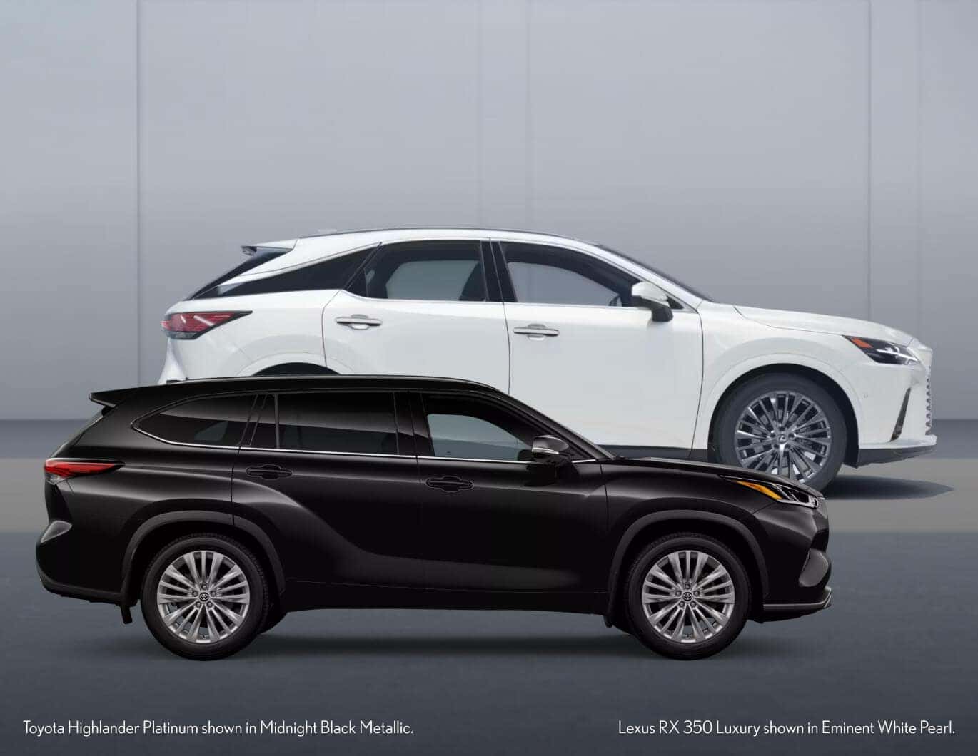 Profile view of Toyota Highlander in Black and Lexus RX 350 in White parked in front of a gray wall.