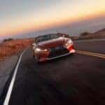 2024 Lexus Convertible Orange driving down a desert road