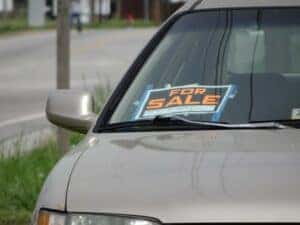 For Sale sign in a car that someone is trying to sell.