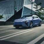 Blue Lexus ES driving through the city