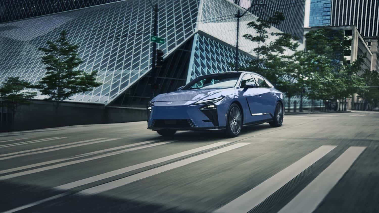 Blue Lexus ES driving through the city