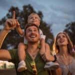 Budget-Friendly Summer Activities for Kids - Family with one child outdoors on summer festival.