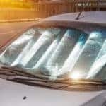 Protective reflective surface under the windshield of the passenger car parked on a hot day, heated by the sun's rays inside the car.