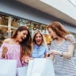 Photo of surprised girls having fun shopping together.